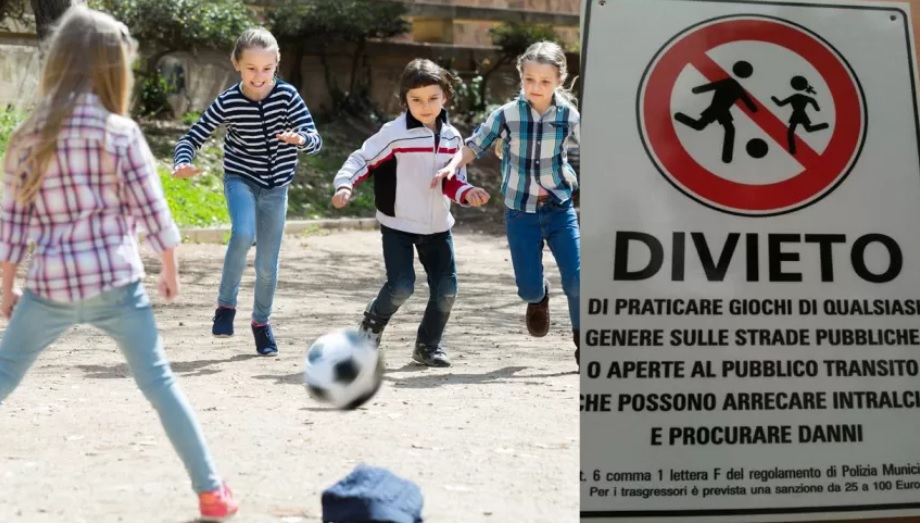 Bambini che giocano a pallone nonostante i cartelli di divieto